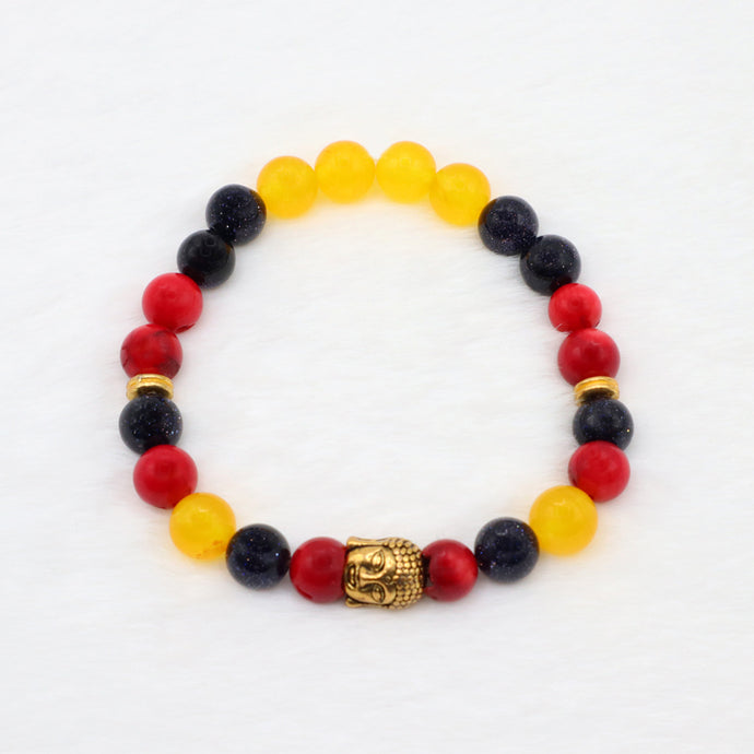 Circle bracelet with red coral, dark blue sparkly sandstone and yellow jade gemstone beads with gold buddha head.