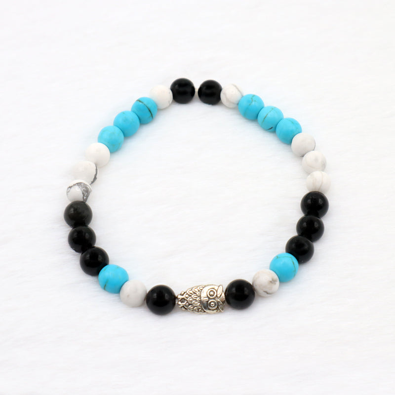 Circle bracelet with turquoise, howlite is a white gemstone with grey swirls and black obsidian gemstone beads with silver owl charm 