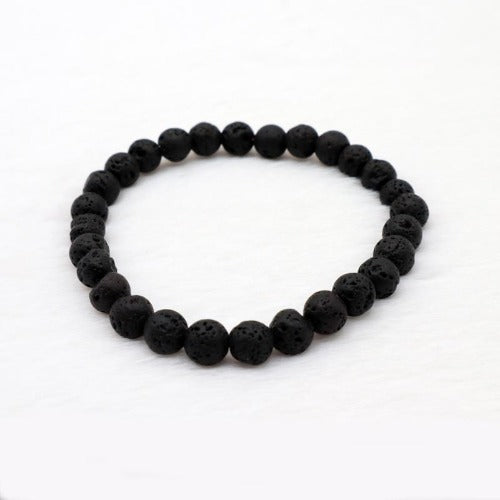 Circle bracelet with black creator beads that are lava stone